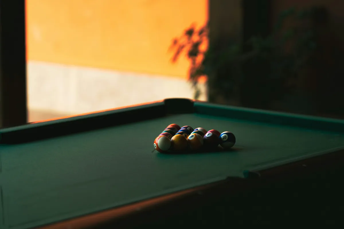 Pool table with balls ready for a game, from the source website